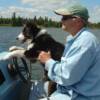 Leah 'driving' the boat with Dad on the Itasca